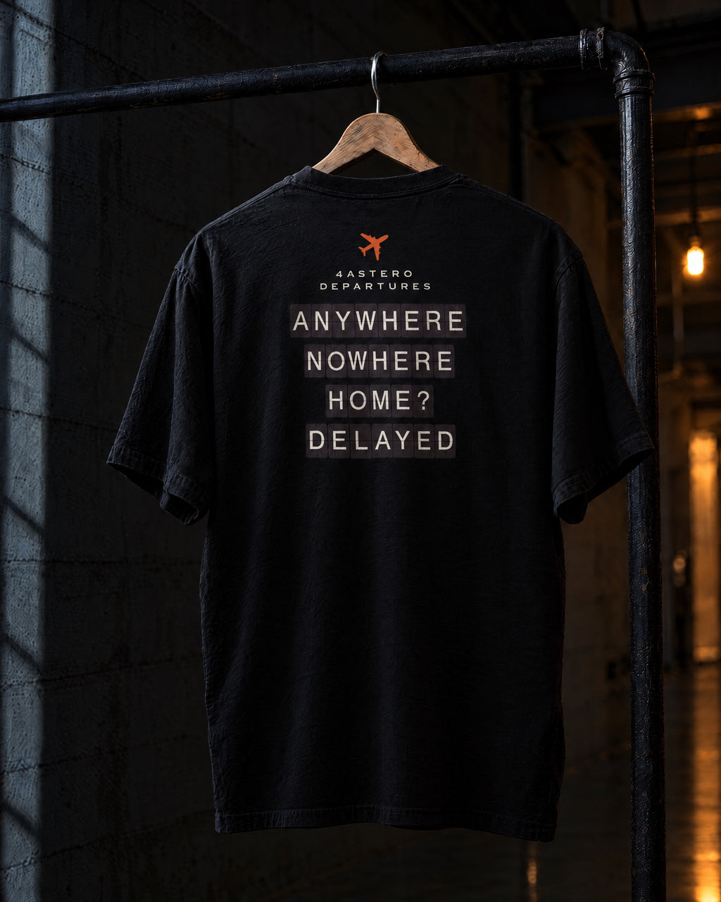 Departures back print on a black 4ASTERO heavyweight tee, on a hanger