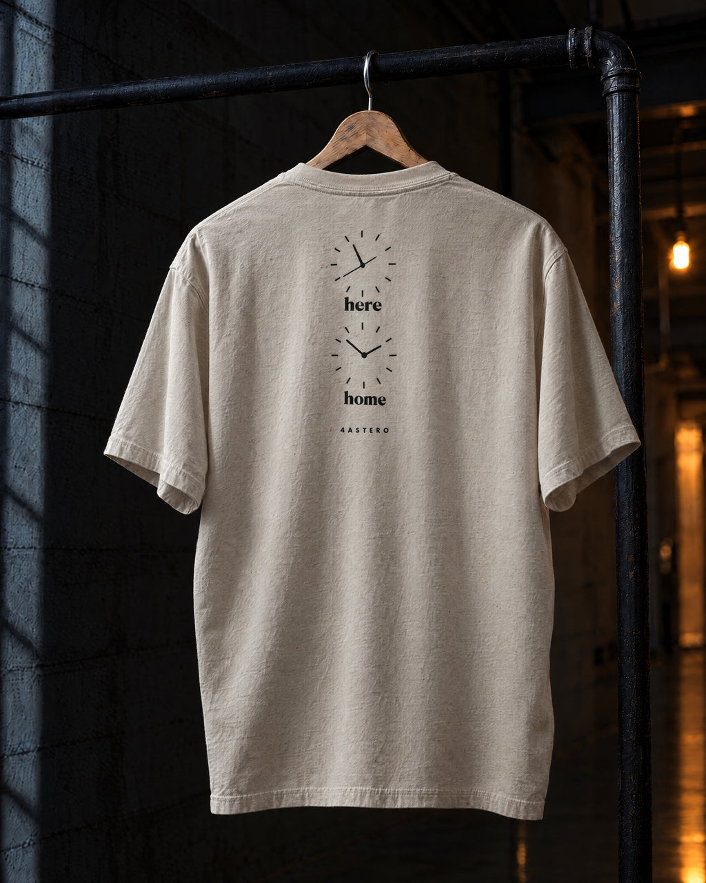 Here / Home back print on a natural 4ASTERO heavyweight tee, on a hanger