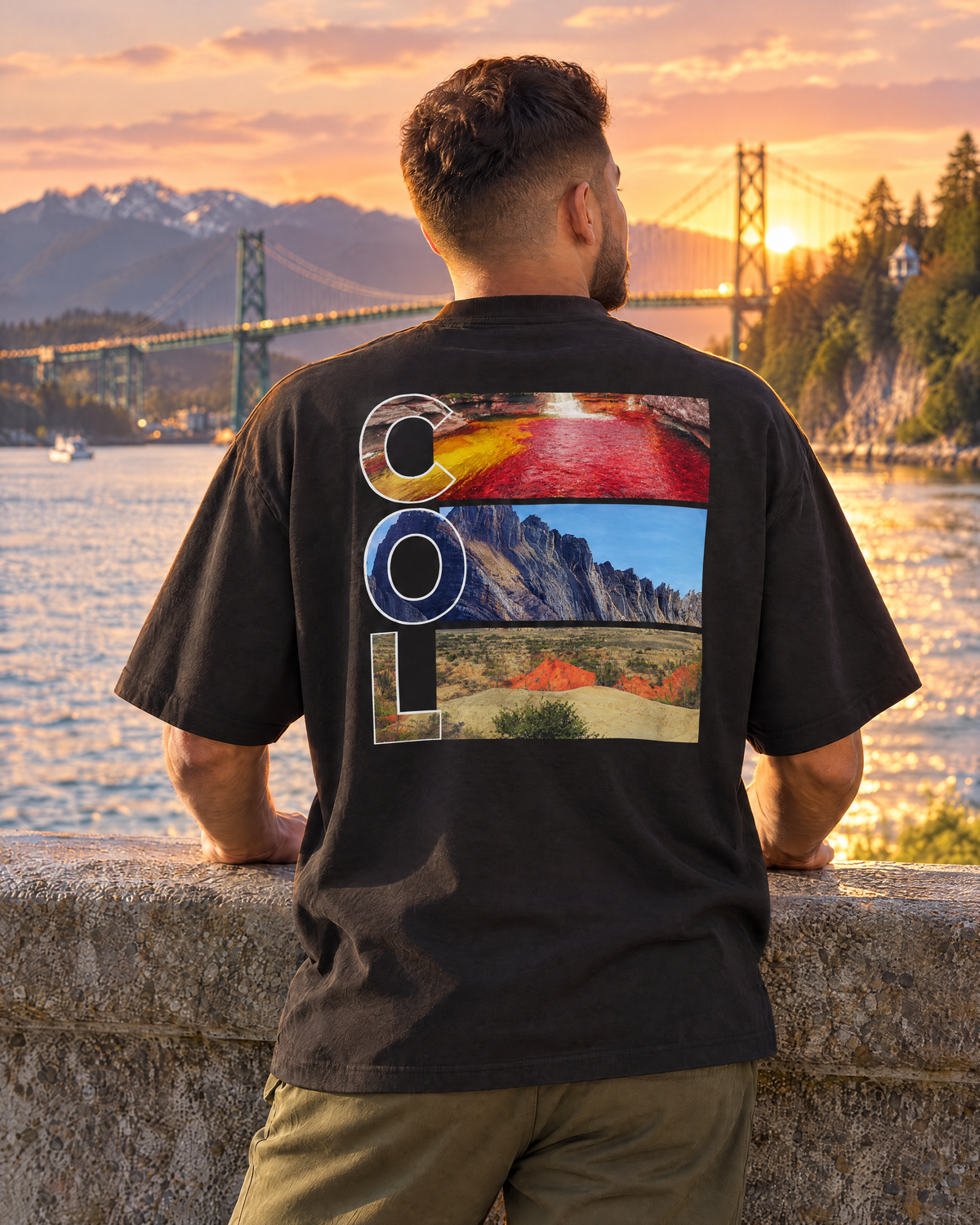 Man in a black 4ASTERO tee with the COL back print on the Stanley Park seawall at sunset