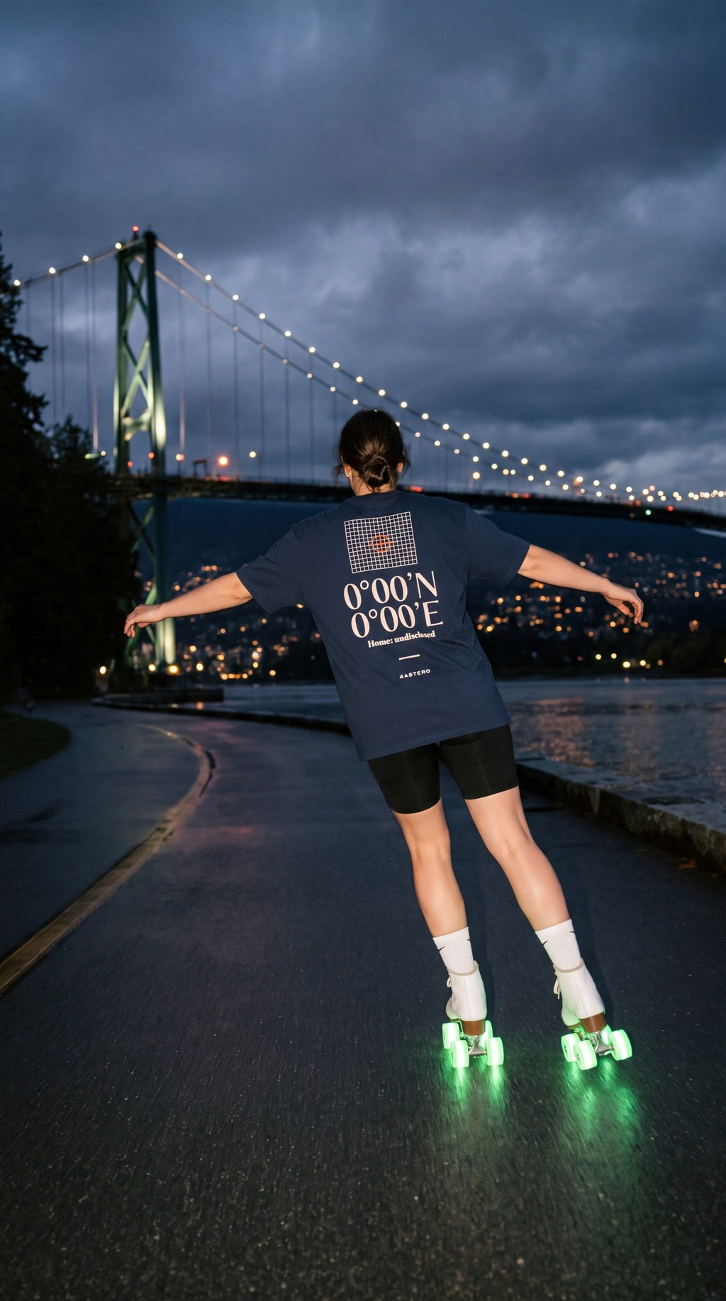 Null Island back print on a navy 4ASTERO tee, Stanley Park seawall at night