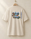 Lugares tee in cream, back, on a hanger