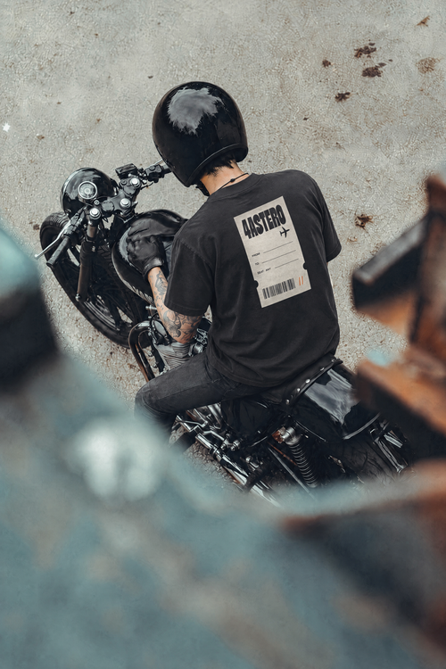 Rider on a motorcycle wearing the black Boarding Pass tee